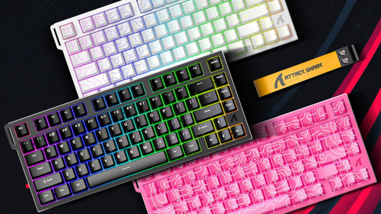 Attack Shark keyboards in white, black, and pink with topographic RGB keycaps and a yellow strap.