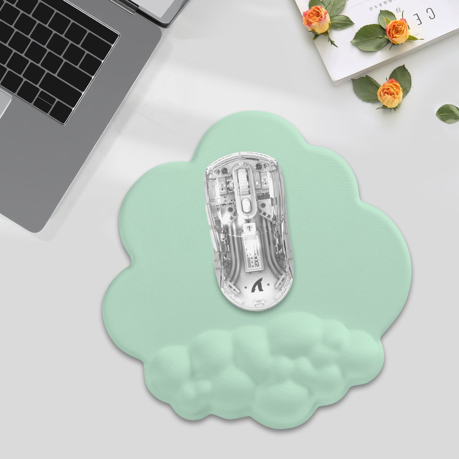 Mint green cloud mouse pad with transparent gaming mouse for ergonomic comfort.