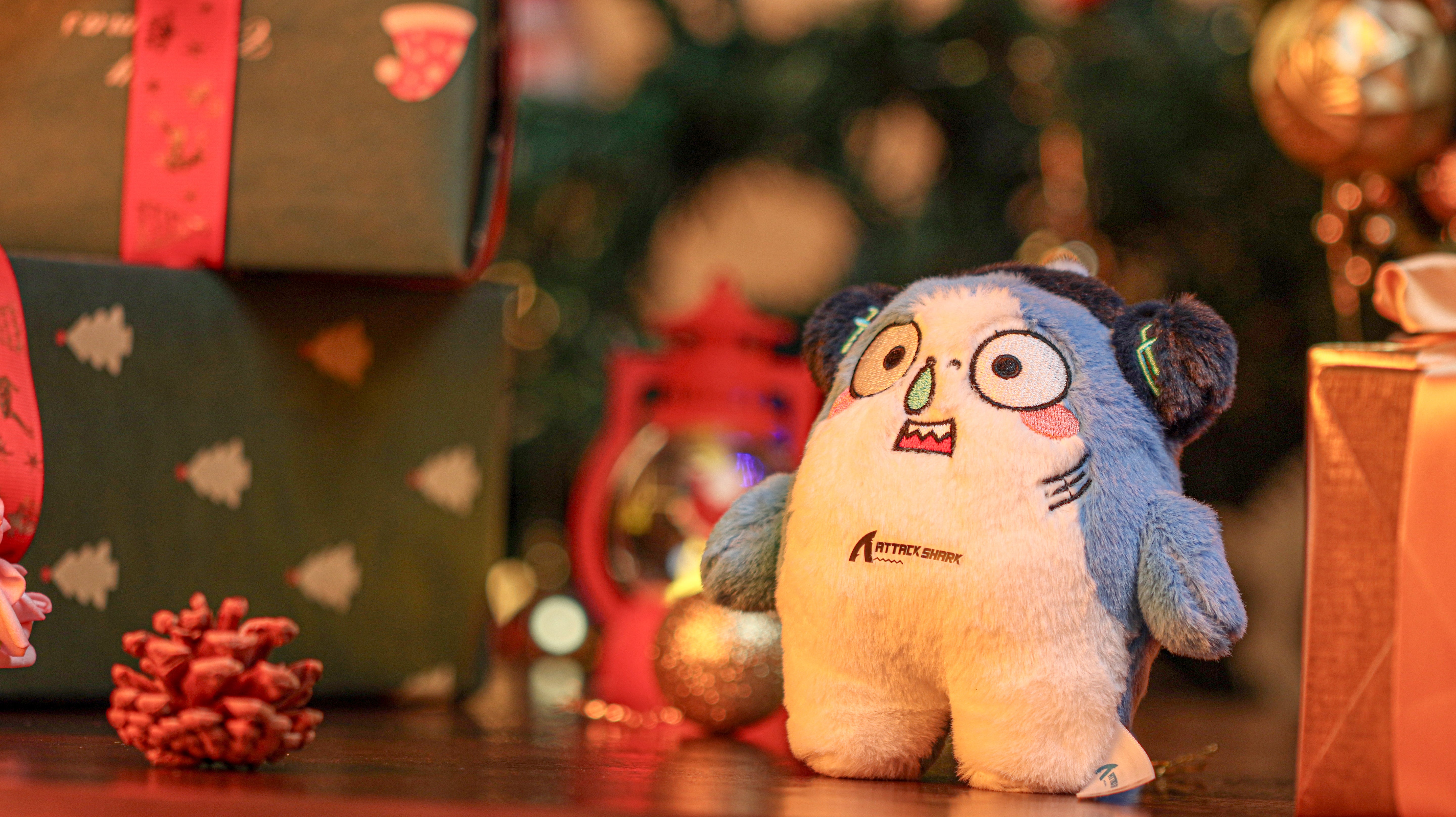 Attack Shark mascot plush toy with Christmas gifts